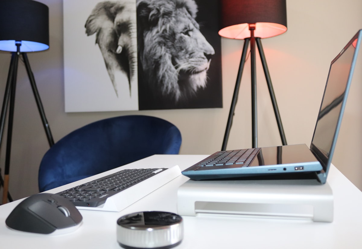 A laptop open on a clean white desk, ready for a productive workspace