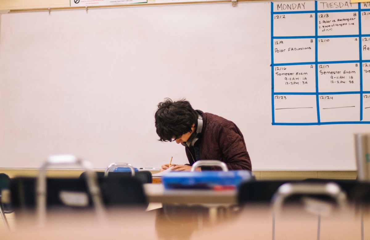 A student sitting at a desk and studying with focus